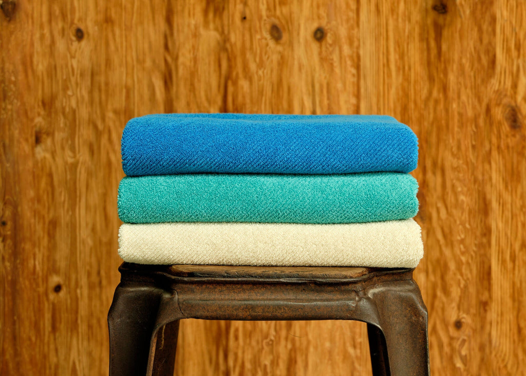 Abyss Twill Towels top-to-bottom in 304 Marina, 302 Lagoon and 101 Ecru